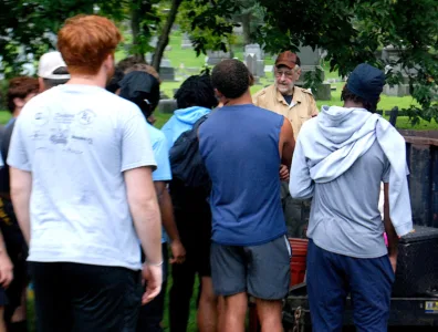 MC football players, community volunteers take on Oak Grove Cemetery cleanup